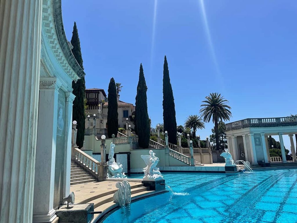 The Neptune Pool at Hearst Castle with marble and serpentine stone patios, marble statues and stairs leading to Casa Grande.